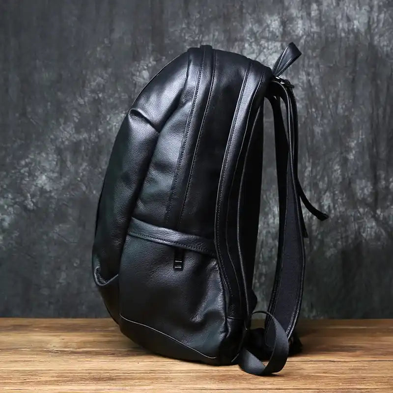 Black leather backpack with an elegant design, side view.