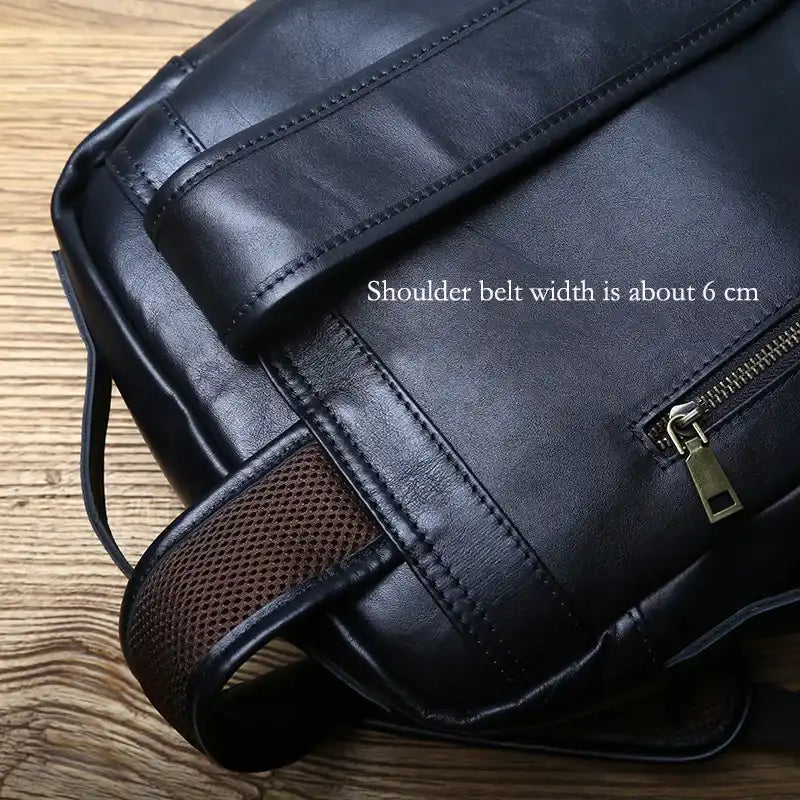 Durable black backpack with a 6 cm wide strap and zippered pocket - back view.