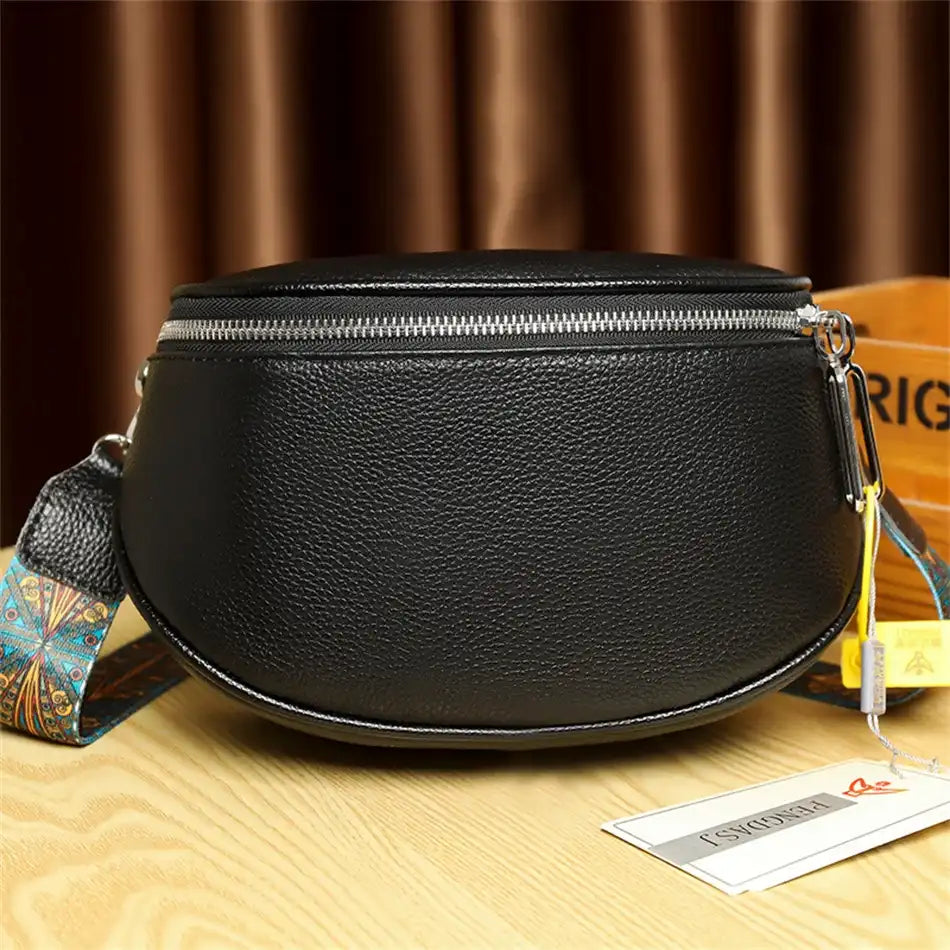 black leather shoulder bag with colored patterned strap - back view.