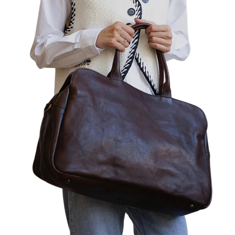 Woman holding an black leather bag displaying a casual yet elegant style - variant.