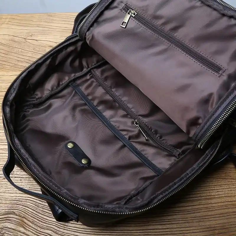 Interior of an organized backpack, showing interior dividers and zipper pockets.