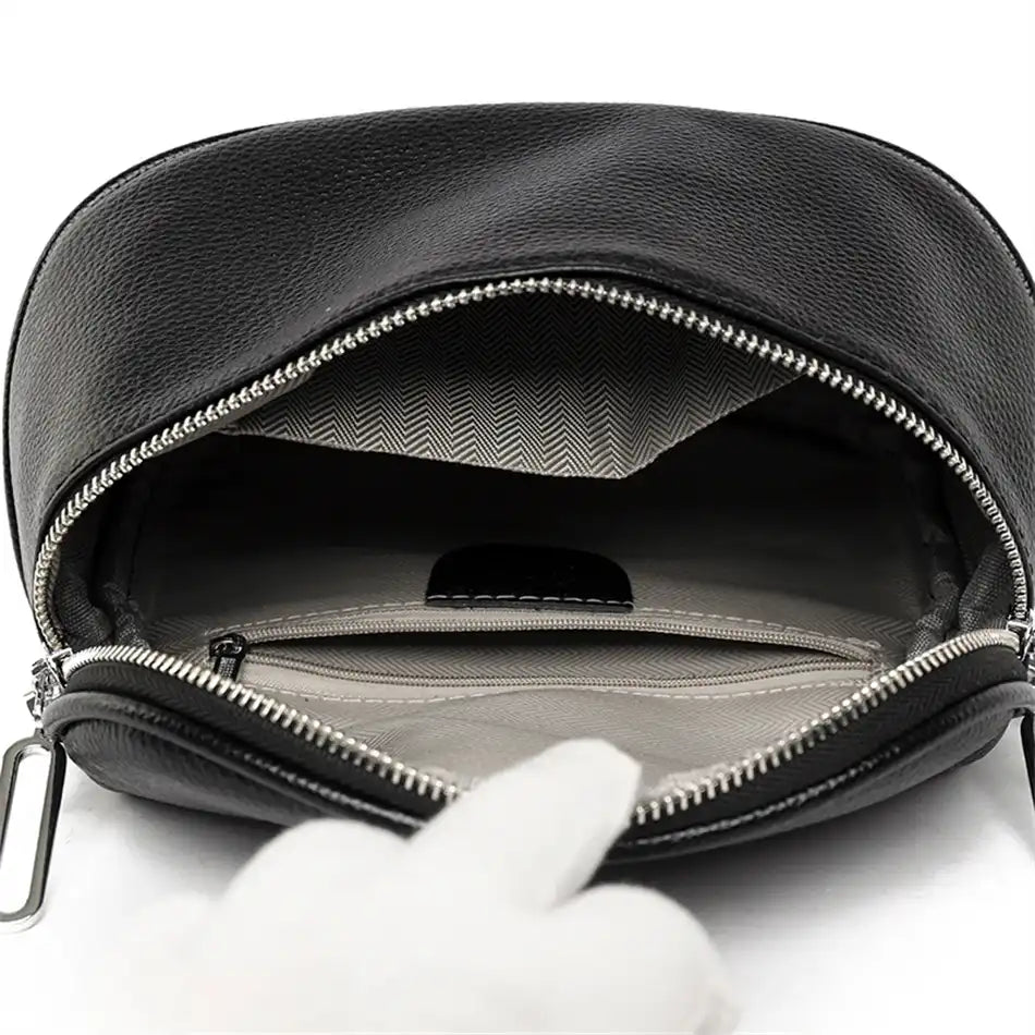 inside view of a black zippered leather bag, highlighting its elegant design and organized interior compartments.