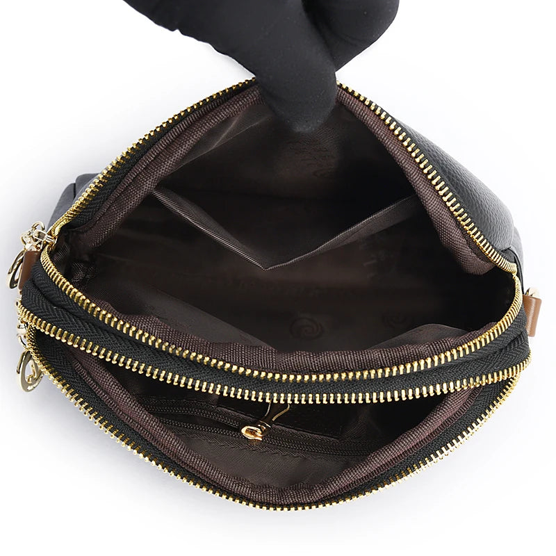 Interior view of a stylish zippered leather bag with interior compartments.