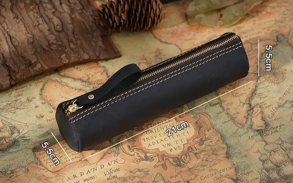 Elegant black leather pen case on an antique map with dimensions.