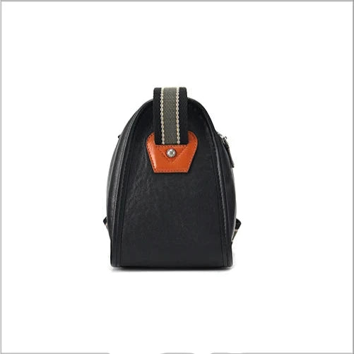 Black leather messenger bag with adjustable striped fabric strap, side view.