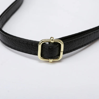 Black leather bag strap with gold buckle, ideal for creating elegant and casual looks.