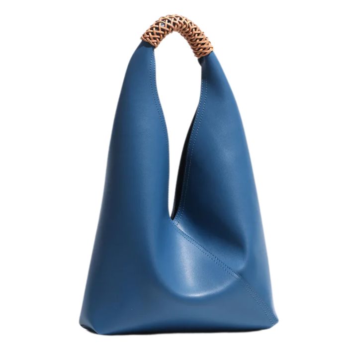 Blue leather handbag with unique design and braided handle, front view.