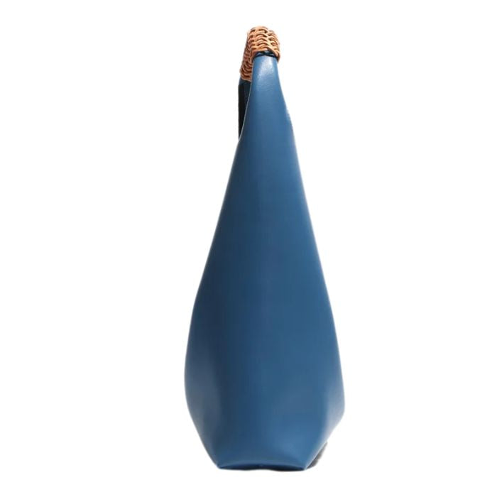 Blue leather bag with a sophisticated shape, and modern, elegant look. Side view.