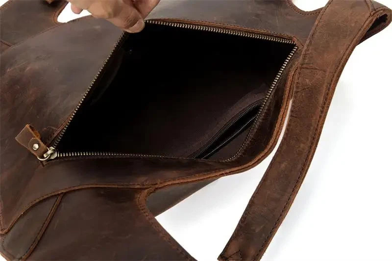 Brown leather bag with zipper, showing its spacious and organized interior.