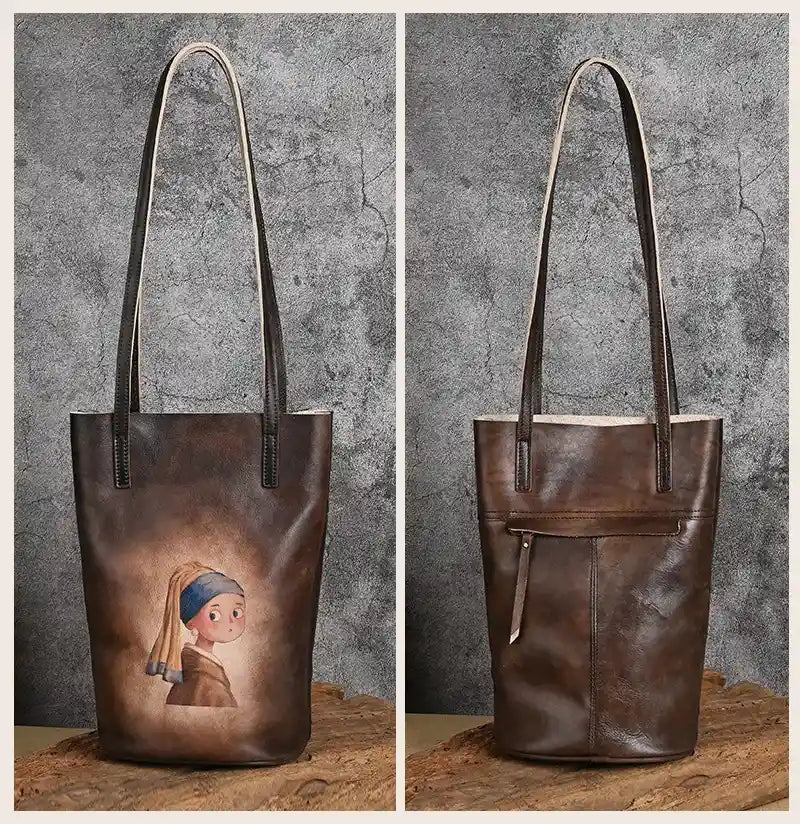 Brown leather tote bag with artistic design print, with leather handles and back zipped pocket, front and back views.
