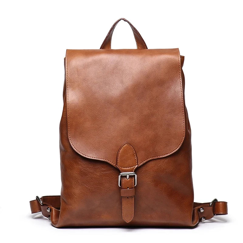 Brown leather backpack with classic design, with sot handle and elegant buckle - front view.