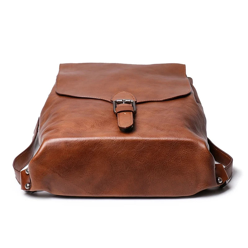 Vintage-inspired brown leather bag with a sleek design with a buckle closure.
