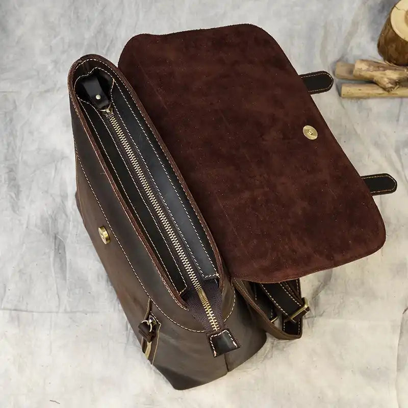 top view of a brown leather bag with zipper closure and suede details.