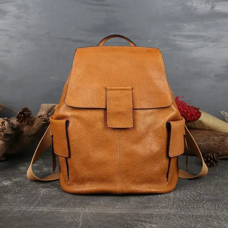 Stylish large brown leather backpack with strap and handle in a minimalist design, front view.
