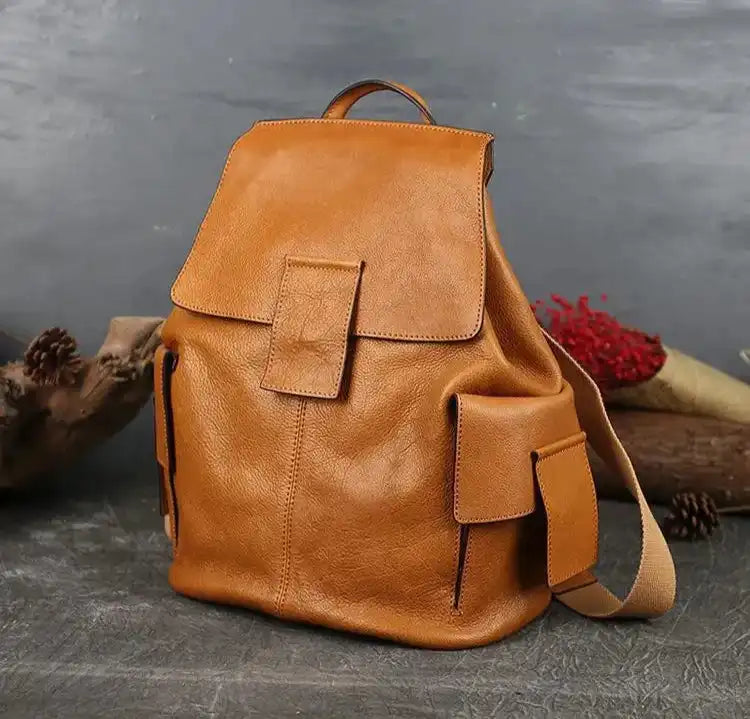 Durable brown leather backpack featuring spacious compartments, front view.