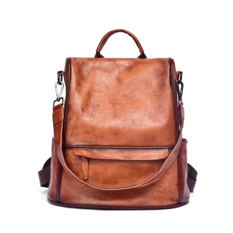Vintage-inspired brown leather backpack with anti-theft design, detachable strap and soft handle.