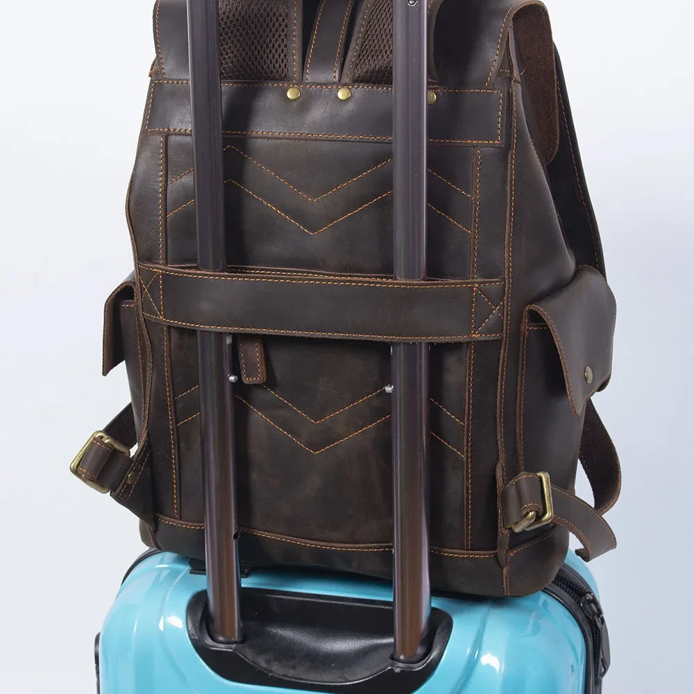 a brown leather backpack attached to a suitcase trolley, ideal for travel and convenient transportation.