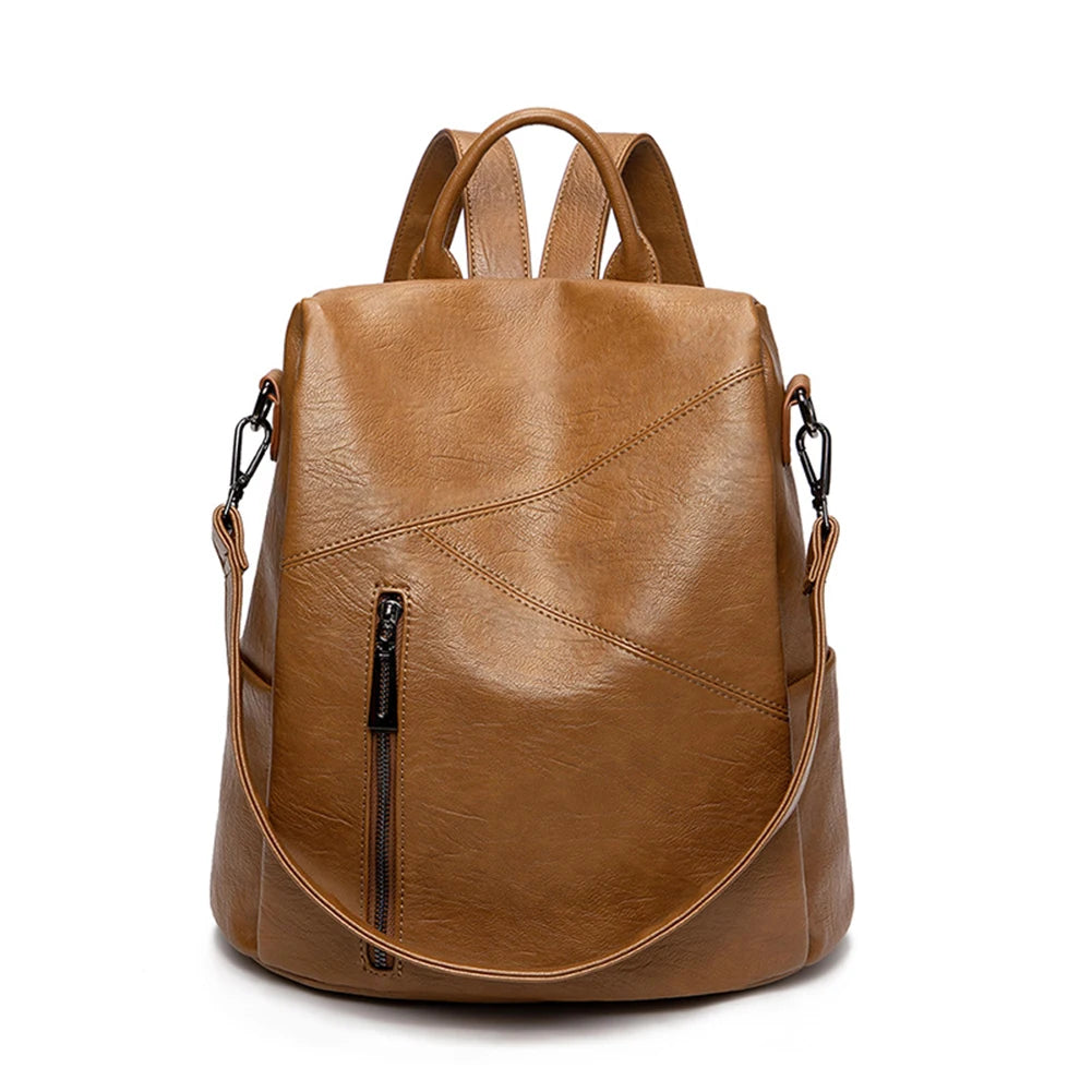 Trendy brown leather backpack featuring a sleek exterior and a front zip pocket - front view.
