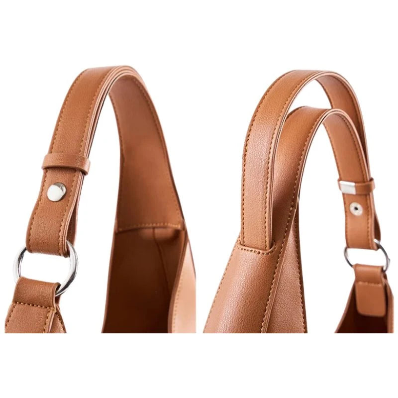 detail of bag leather straps in brown-colored  featuring stitching details and silver buckles.