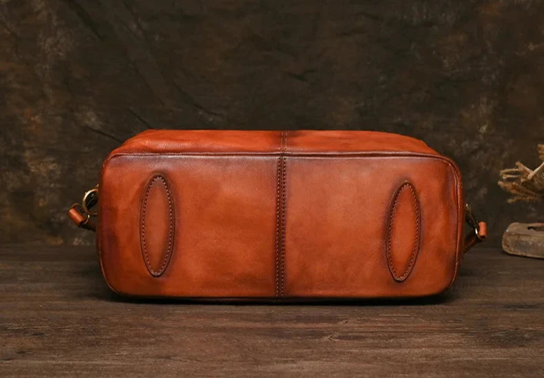 bottom view of a brown leather bag with an elegant design and high-quality finishes.