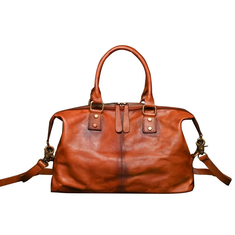 Vintage style brown leather bag with handles and large compartment, front view. 