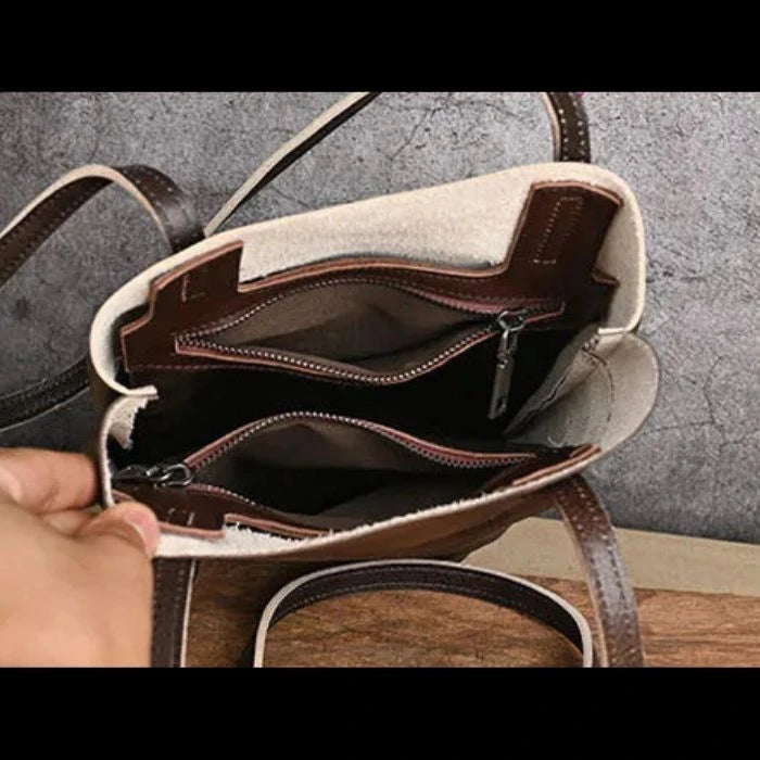 interior view of a stylish brown handbag with multiple compartments and zipped pockets.