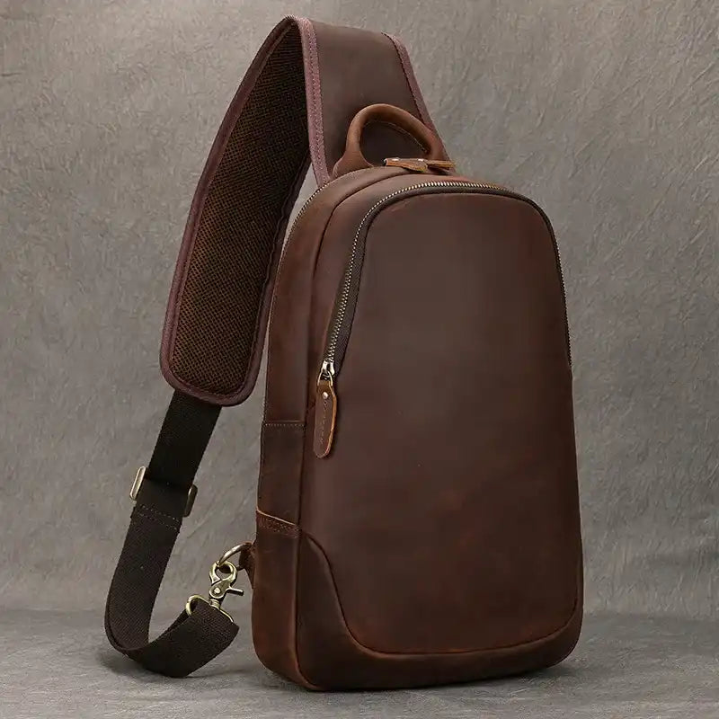elegant brown leather shoulder bag with a modern design, adjustable strap, and soft handle - front view.