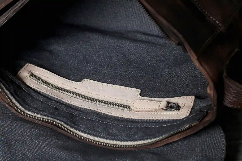 Interior view of a leather bag showing a zippered pocket, highlighting its structure and quality materials.