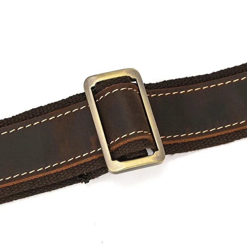 Brown leather bag belt with metal buckle. Durable and resistant accessory.