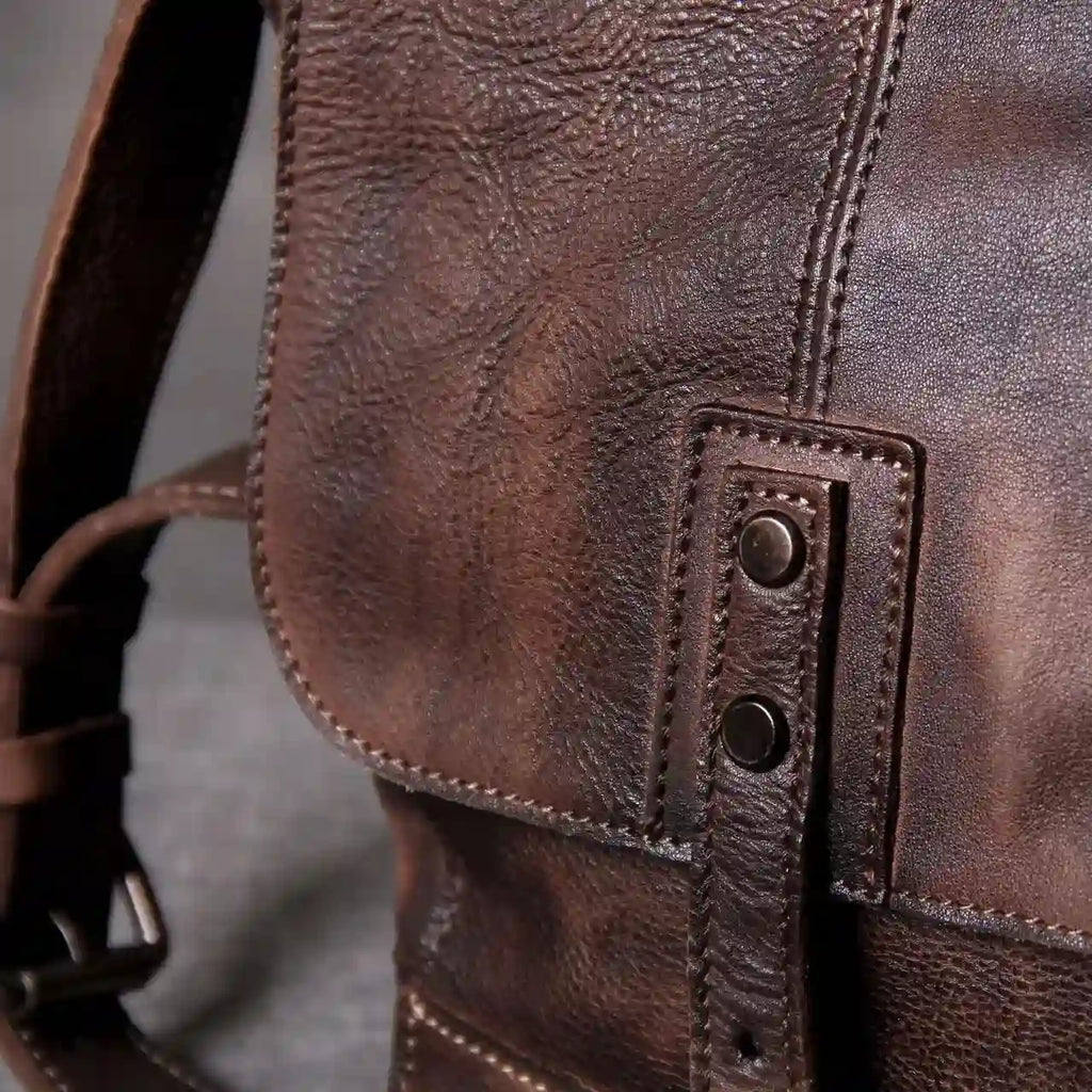 Detail of a brown leather bag, highlighting the rich texture and stitching.