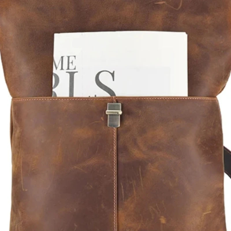 Brown leather bag with a document visible on top. Ideal for professionals looking for style.