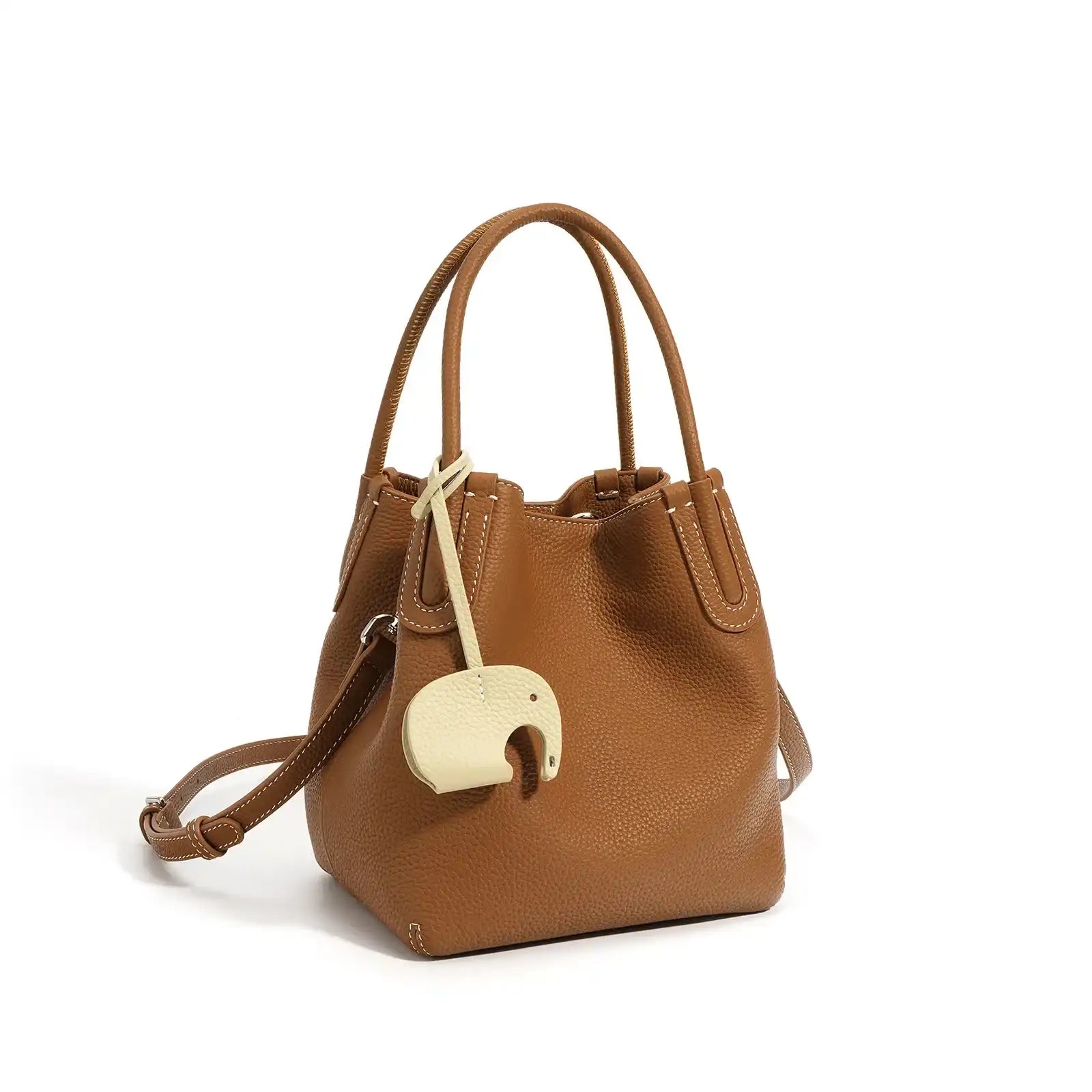 A stylish brown leather bucket bag with a unique elephant charm - front view.
