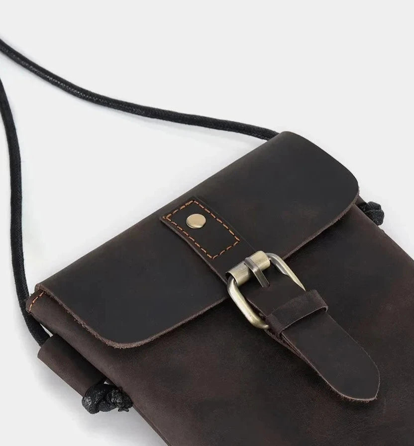 closeup of a brown leather bag with metal closure and drawstring handle, ideal for carrying essential items in style.