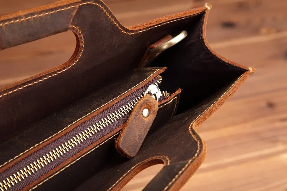 Interior view of a leather bag, highlighting details such as the zipper and lining. 