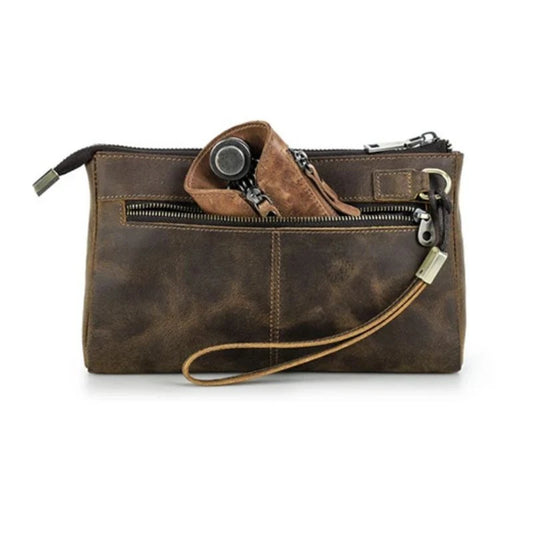 Brown leather clutch with zippers, showing an elegant and functional design, back view.