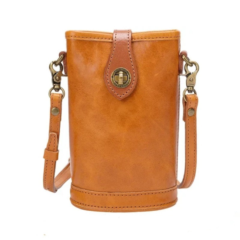 Brown leather crossbody bag with gold accents on a white background