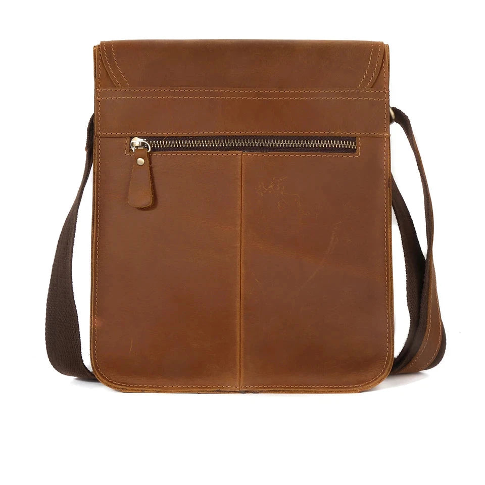 Brown leather crossbody bag with elegant design, zipper closure and shoulder strap, back view.