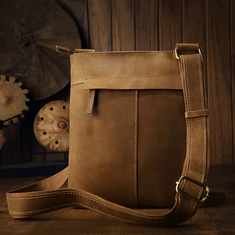Brown leather crossbody bag, with adjustable strap, stylish design and back pocket for essentials - back view.
