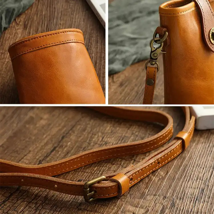 a brown leather bag with metal details and an adjustable strap. The piece features an elegant and modern design.