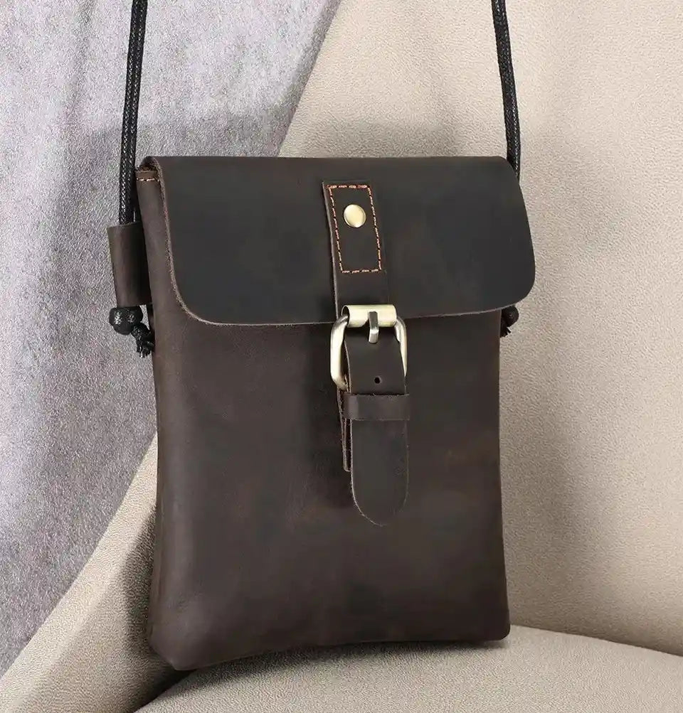 Brown leather crossbody bag with elegant clasp, ideal for a casual and modern style - front view.