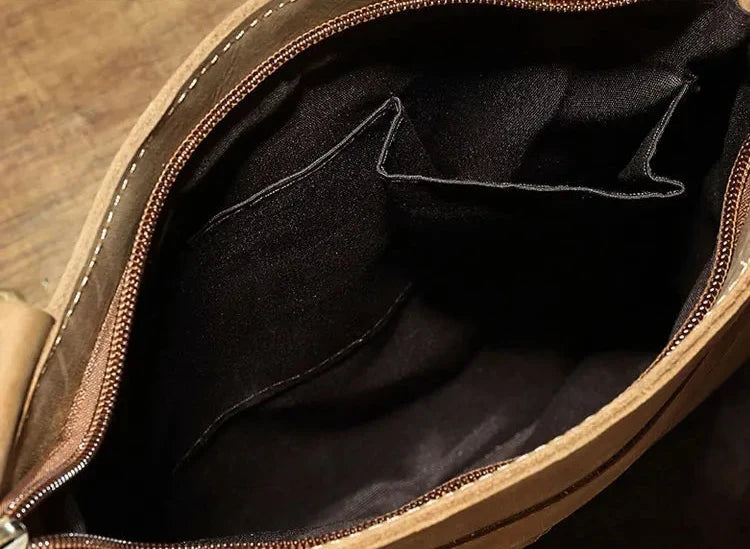 	
Interior image of a leather bag, highlighting the compartments and interior pockets for organization and style.