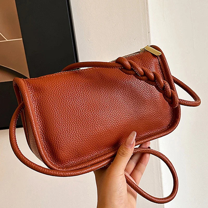 Stylish brown leather crossbody bag with braided strap - front view