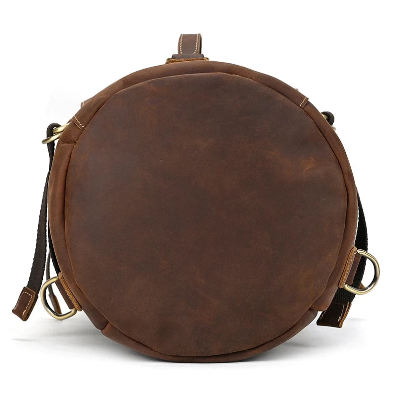  Round brown leather duffle bag using high quality materials and functional design, bottom view.