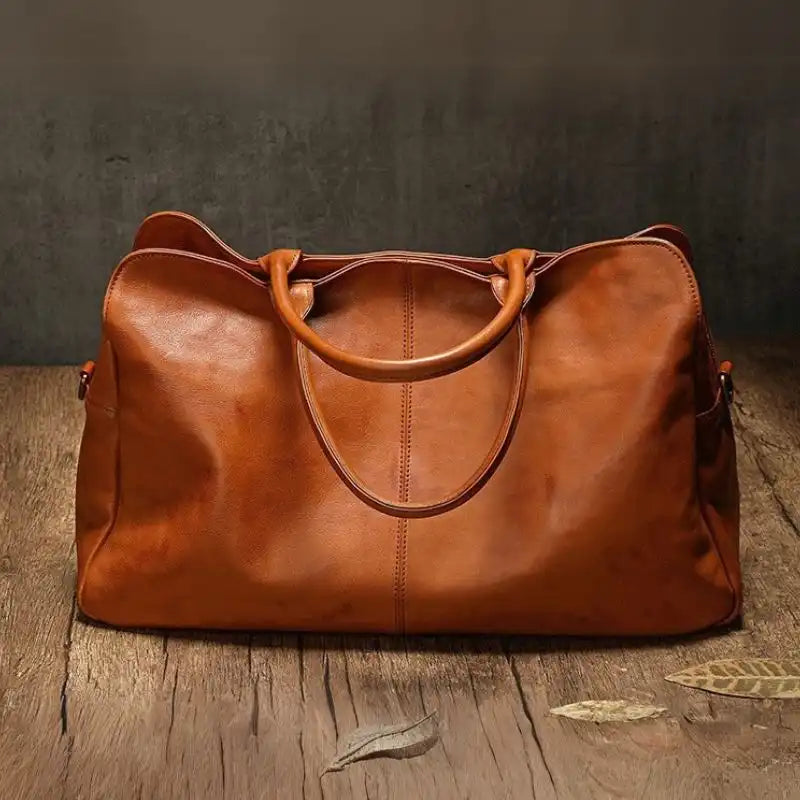 Brown leather handbag with an elegant and modern design, stylish soft handles and detachable strap, back view.