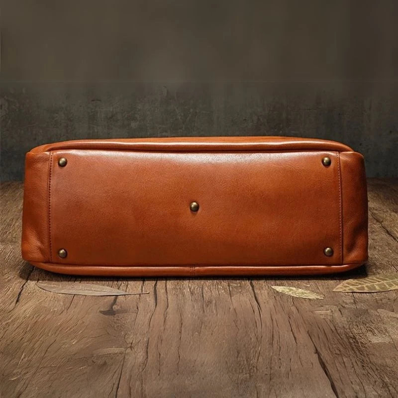 Brown leather bag with metal details,  reflecting sophistication and style. Bottom view.