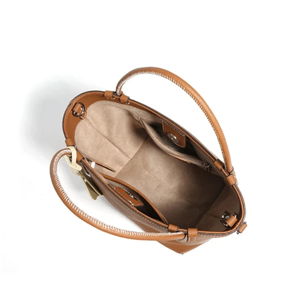 interior of a brown leather handbag, featuring a stylish design and spacious compartments.