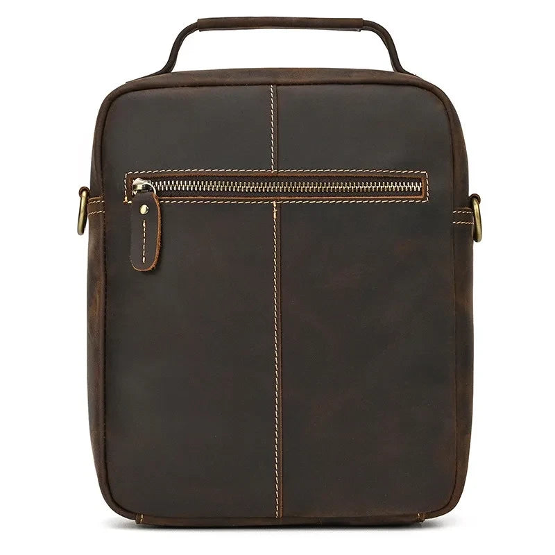 coffee brown leather suitcase with back zipped compartment and soft handle - back view.