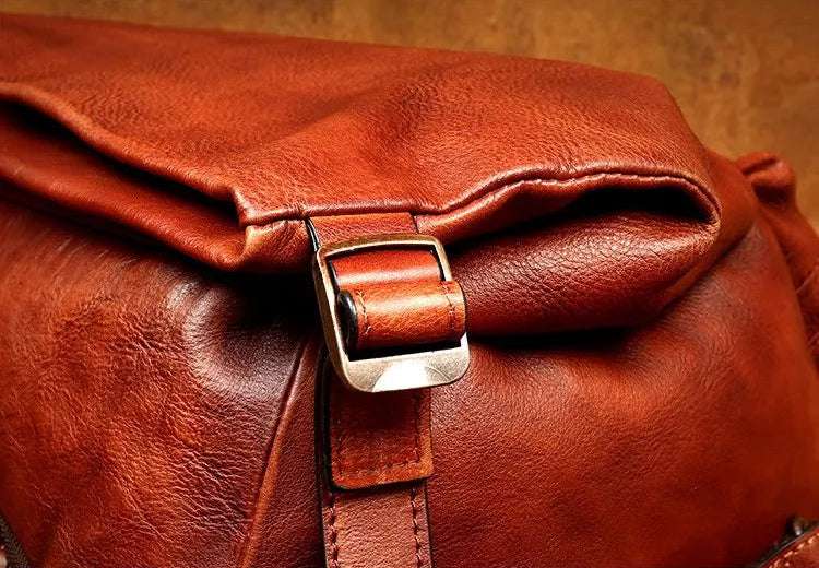 Close-up of a stylish brown leather bag with a metal buckle.