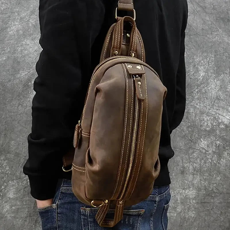 Casual style brown leather shoulder bag, with a distinctive zipper finish worn on man shoulder.