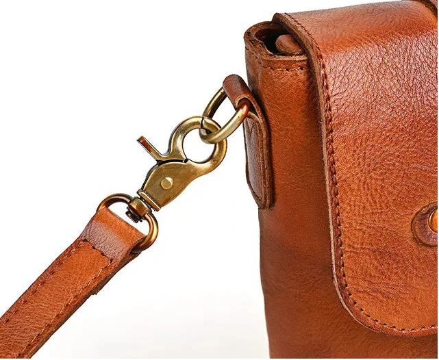 Stylish brown leather bag with a clasp and strap detail.